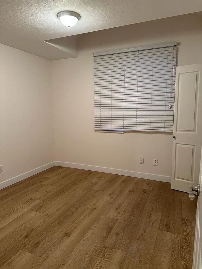 Unfurnished room with wood finished floors and baseboards | Image 10