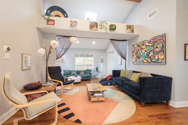 Living area and family room with ledge dividing them! Note high ceilings, skylight, huge windows looking out to porch! | Image 27