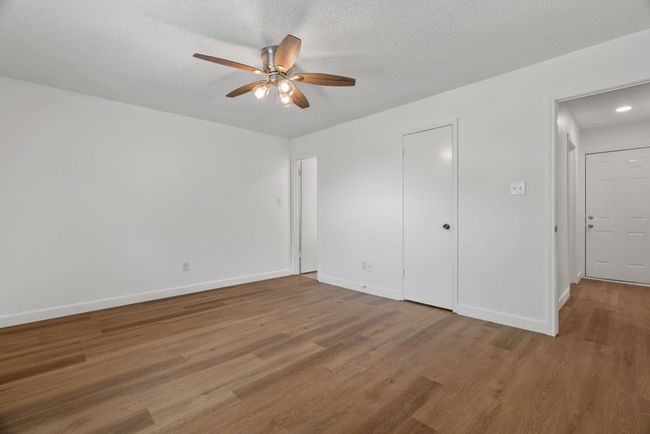 Unfurnished bedroom with light wood finished floors and ceiling fan | Image 21