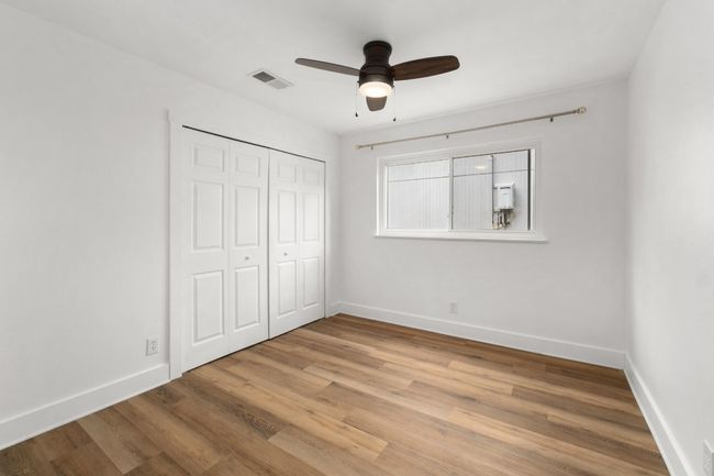 Unfurnished bedroom with light wood-style flooring, a closet, and ceiling fan | Image 16