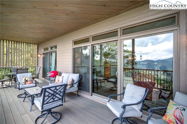 Here is the very private, expanded living area. Sliding glass doors lead from both the living area and primary suite onto the covered deck. | Image 15