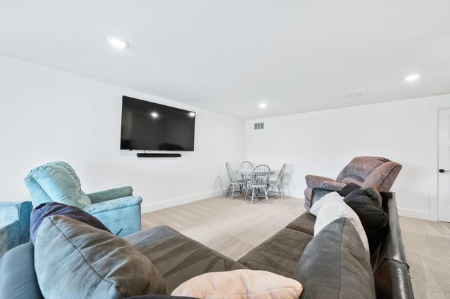 Living room with light carpet, recessed lighting, and baseboards | Image 25