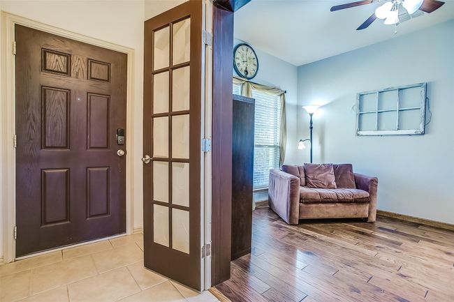 Study or home office off of the entry with french doors & the room has a ceiling fan. | Image 4