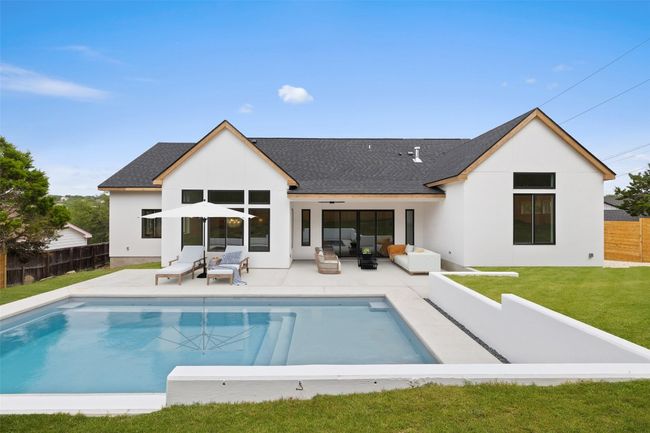 Back of property with an outdoor hangout area, stucco siding, roof with shingles, and a patio | Image 26
