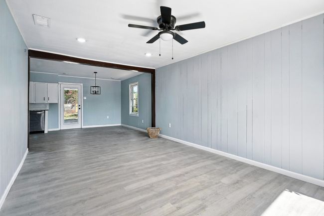 Unfurnished living room with wood finished floors and ceiling fan | Image 6