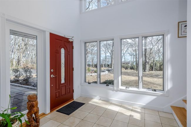 Entrance foyer with stairway, plenty of natural light, baseboards, and light tile patterned flooring | Image 4
