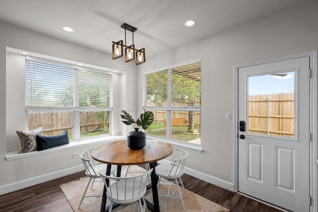 Dining room featuring baseboards, wood finished floors, recessed lighting, and a chandelier | Image 12