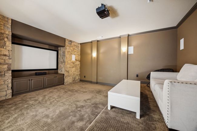 Cinema featuring carpet floors and crown molding | Image 19