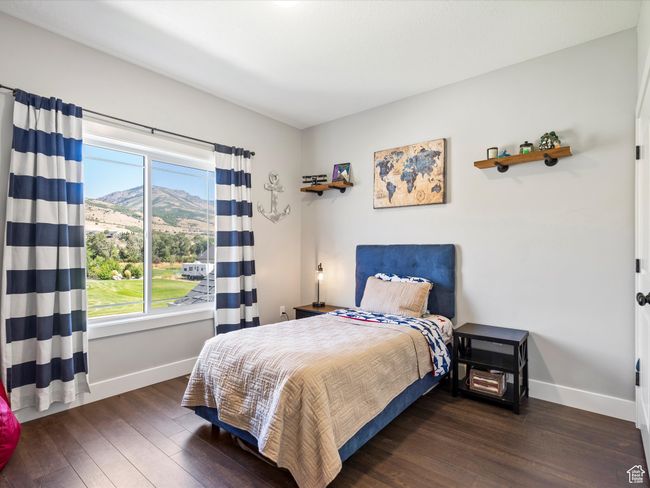 Bedroom featuring baseboards, wood-type flooring, and a mountain view | Image 37