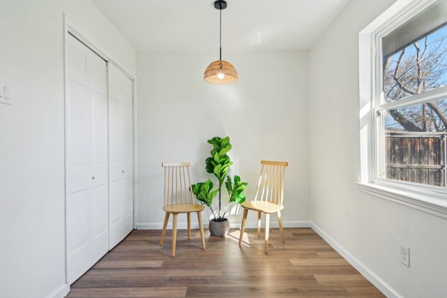 Living area with plenty of natural light, wood finished floors, and baseboards | Image 11