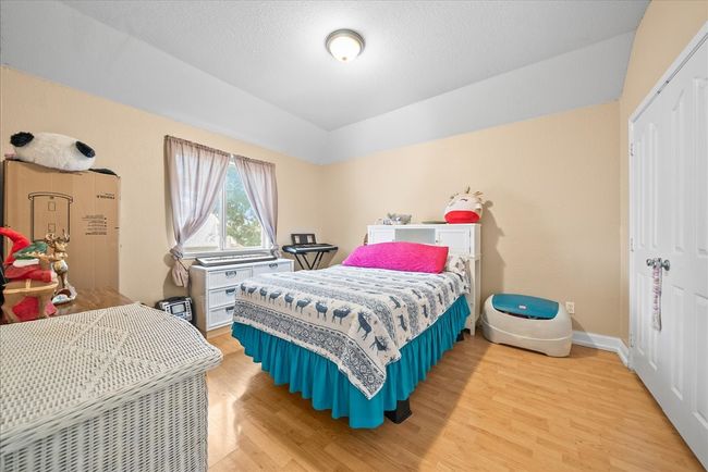Bedroom featuring light wood-style flooring, a closet, and baseboards | Image 34