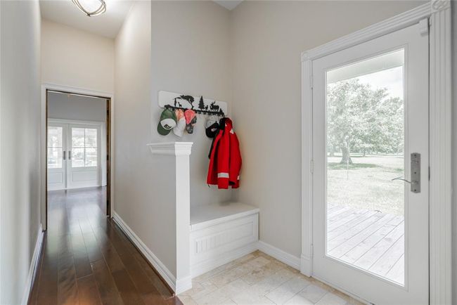 This is a mud room area with built in storage under the built in seat. Travertine on the floor in this area as well, and, of course, a door leading out to the porch. | Image 26