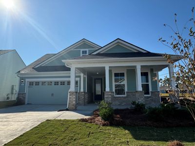 Craftsman inspired home with a porch, a front yard, and a garage | Image 1