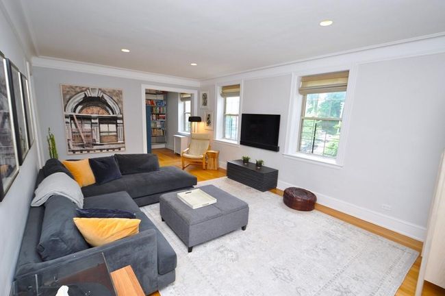 Large corner living room has recess lighting, built-in speaker system, hardwood floors and a nook that is a great place for an office. The living room is 20'-7" x 13'-3" The office nook is an additional 8'-9" x 6'-9". | Image 4