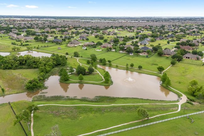 Van Zandt Farms is built around this beautiful pond, with walking trails for getting your steps in each day! | Image 39