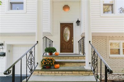 Entrance to property with a garage | Image 1