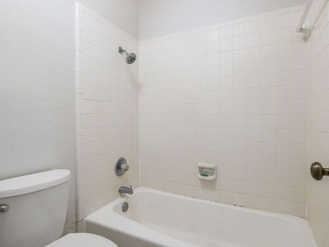 Bathroom featuring toilet and bathing tub / shower combination | Image 16