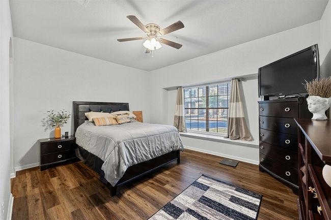 Primary bedroom with wood-type flooring, ceiling fan and window seat | Image 12