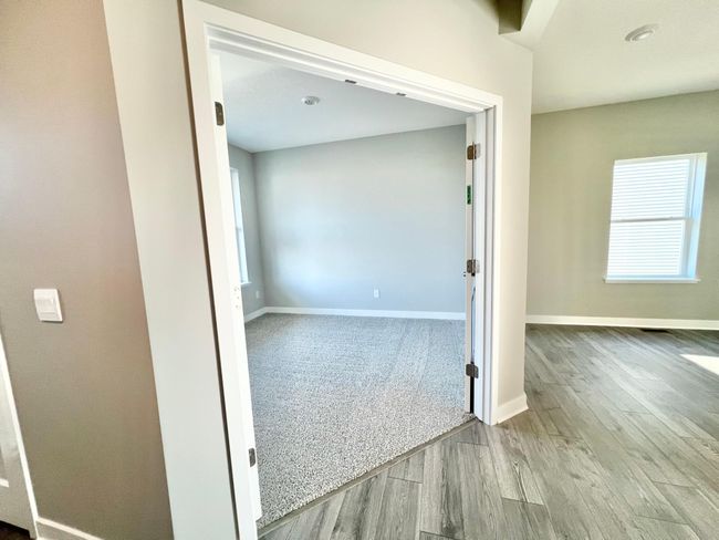 Actual home: Main level office/flex room with french doors, just off the front entry to home, with a view of the two-sided fireplace. | Image 21