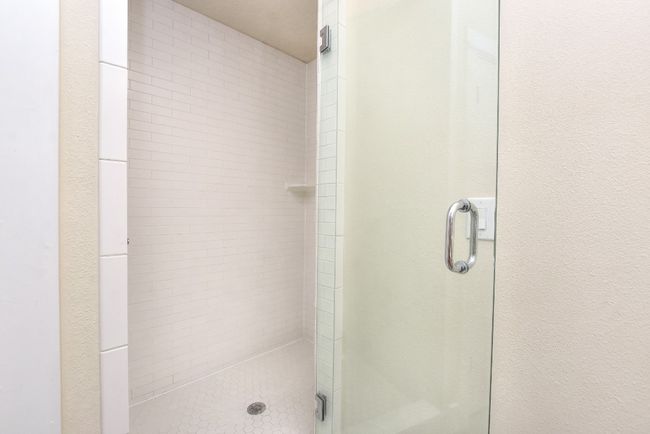 Primary tiled shower and glass door | Image 25