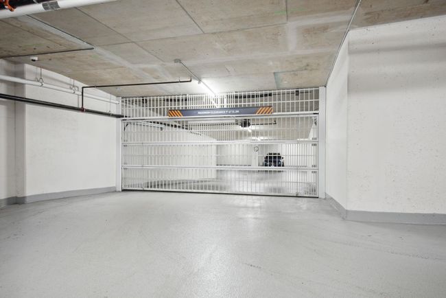 Garage with baseboards | Image 27