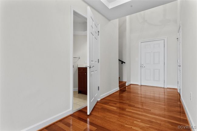 Hallway featuring baseboards, light wood-style flooring, and stairs | Image 19