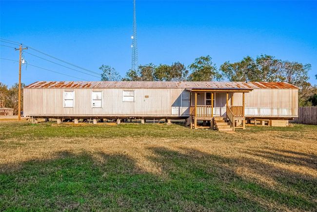 This charming 3-bedroom, 2-bath manufactured home features an open floor plan with a spacious living area, open kitchen, and comfortable bedrooms. | Image 6
