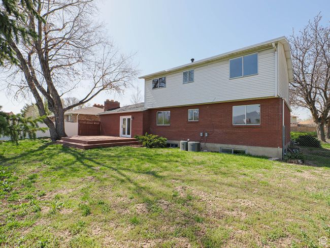 Back of house featuring a wooden deck and brick siding | Image 16