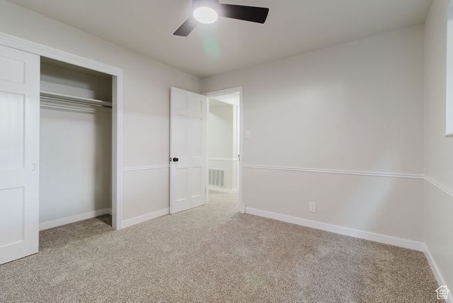 Unfurnished bedroom featuring baseboards, a closet, visible vents, and carpet | Image 11