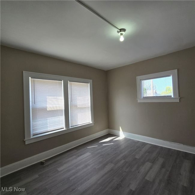 with baseboards and dark wood-style floors | Image 11