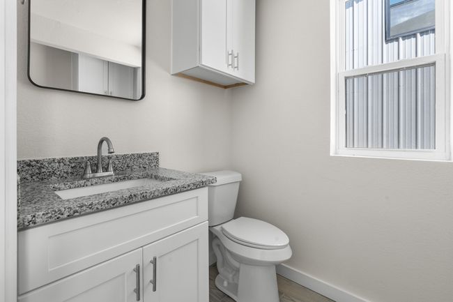 Half bathroom with vanity and wood finished floors | Image 9