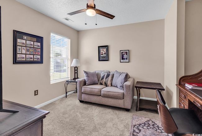 Carpeted, ceiling fan and a textured ceiling | Image 8