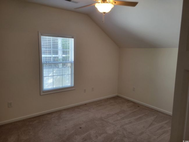 Additional living space featuring a ceiling fan, carpet flooring, and vaulted ceiling | Image 23