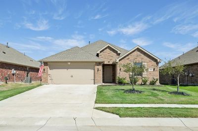 View of front of home featuring a front yard, central air condition unit, and a garage | Image 2