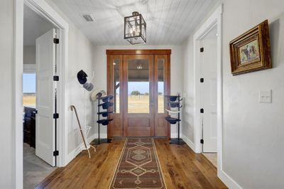 Entryway with wooden ceiling, dark hardwood / wood-style floors, and a wealth of natural light | Image 2