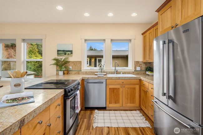 The kitchen is thoughtfully designed with an abundance of storage and ample counter space, offering a perfect blend of functionality and style. | Image 12