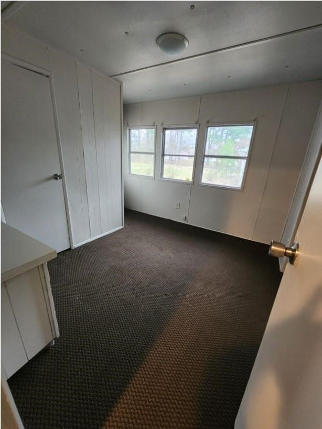 Unfurnished room with dark colored carpet | Image 16
