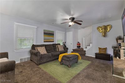 Carpeted living room with ceiling fan | Image 3