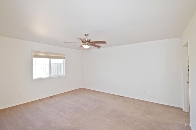 Spare room featuring light carpet and ceiling fan | Image 12