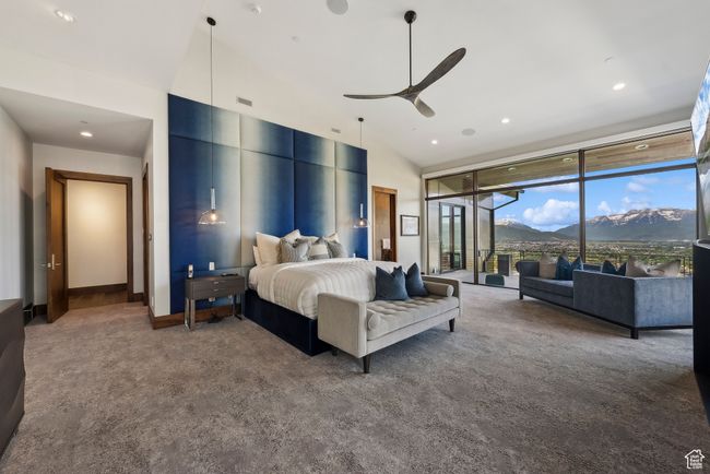 Bedroom with carpet flooring, a mountain view, high vaulted ceiling, a wall of windows, and access to outside | Image 28