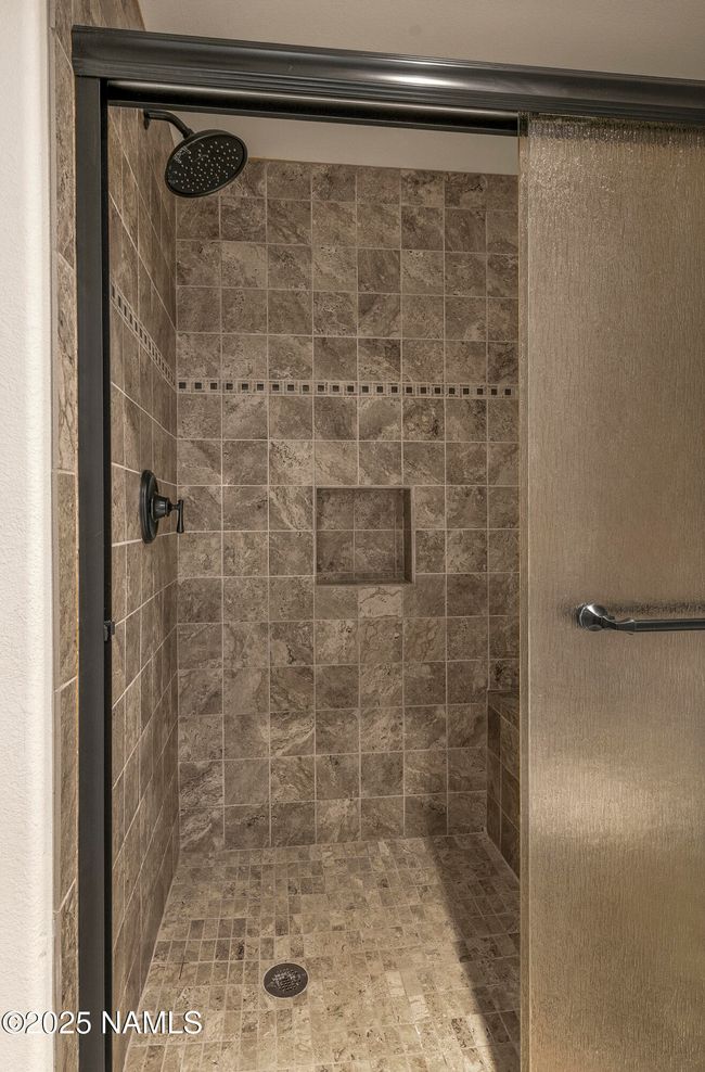 Beautifully tiled shower. | Image 11