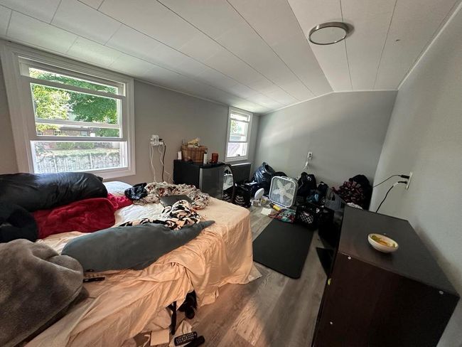 Bedroom with vaulted ceiling and wood finished floors | Image 11