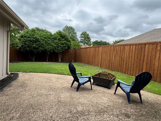 View of patio featuring a recent board on board wood privacy fence | Image 34