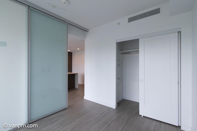 Unfurnished bedroom featuring wood finished floors, baseboards, a closet, and recessed lighting | Image 5