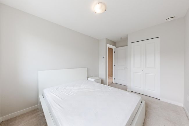 Bedroom with light colored carpet and a closet | Image 22