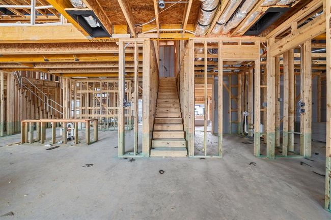 A secondary staircase by the kitchen offers easy access and smart design. | Image 15