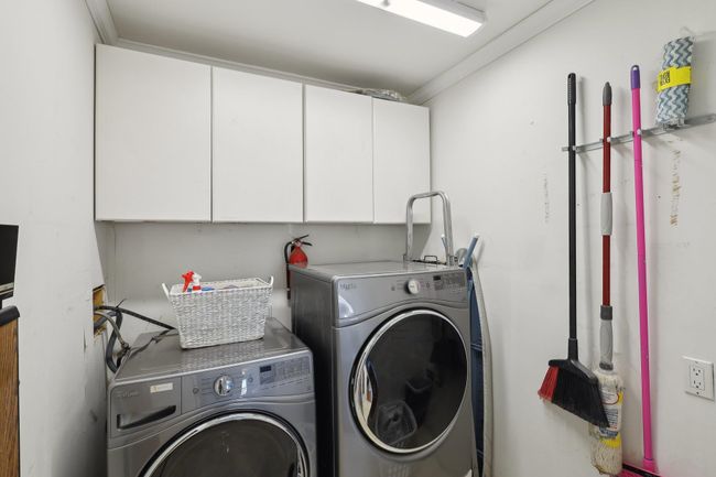 Laundry room featuring independent washer and dryer and cabinet space | Image 32