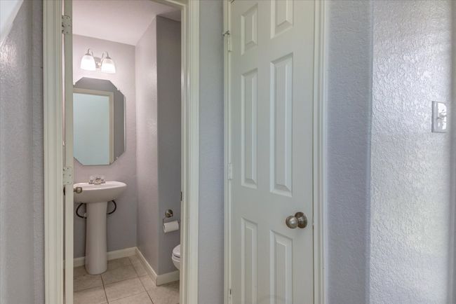 Downstairs half-bathroom with pedestal sink. | Image 17