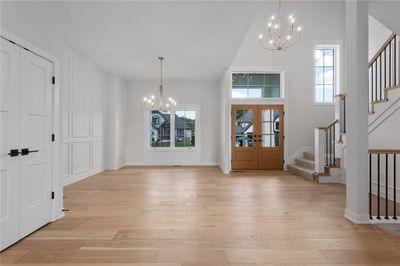 Foyer featuring french doors, light hardwood / wood-style floors, and a notable chandelier | Image 2