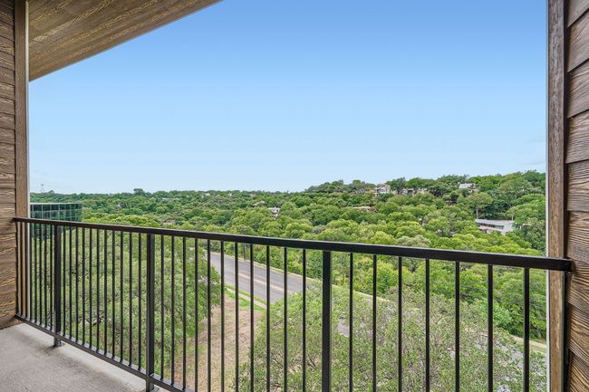 Balcony with a view of trees | Image 19